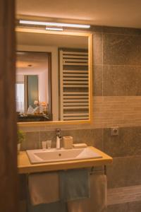 ein Bad mit einem Waschbecken und einem Spiegel in der Unterkunft Garni Stefani in Vent