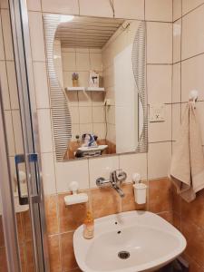 a bathroom with a sink and a mirror at City Center White Apartment! in Skopje +25 photos
