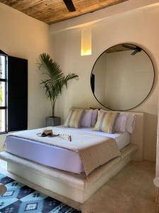 a bedroom with a large bed with a large mirror at Casa De Amigos Hotel Boutique in Honda