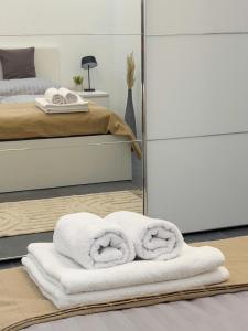 a room with a bed with towels on the floor at Apartment K21 - Győr in Győr