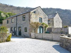 an old stone building with a fence in front of it at 3 bed in Cressbrook 57037 in Cressbrook