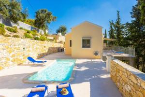 a villa with a swimming pool and a house at Villa Alexandros in Gaios