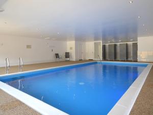 una gran piscina de agua azul en un edificio en 3 bed in Taunton KIBOR en Trull
