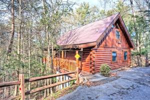 a log cabin in the woods with a fence at Mick's Hideaway - Semi-Secluded in Sevierville