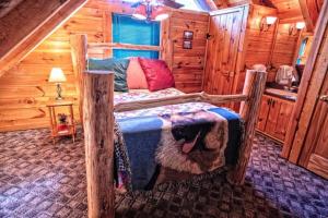 a bedroom with a bed in a log cabin at Mick's Hideaway - Semi-Secluded in Sevierville