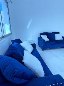 un sofá azul con almohadas en la sala de estar en Luxury in Paradise 2 en San Felipe de Puerto Plata