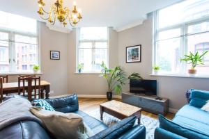 a living room with a couch and a table at Stylish City Centre 2 Bed Apartment - Free Parking in Manchester