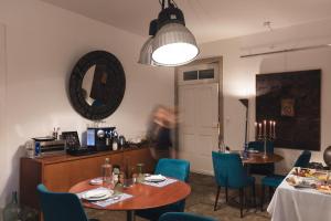 a dining room with two tables and blue chairs at Oporto Loft in Porto