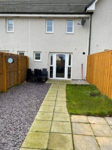 a house with a fence and a pathway in front of it at Modern 3bed house in central location & free parking in Aberdeen