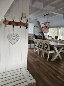 a kitchen and dining room with a table and chairs at Het Hertenbos chalet 136 in Durbuy