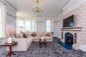 a living room with a couch and a fireplace at The Priory House in Tynemouth