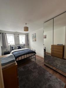 a bedroom with two beds and a mirror at ABBA Heights in London
