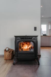 a fireplace in a living room with a fire in it at Villa ADurbuy avec Jacuzzi in Durbuy