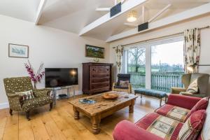 a living room with a couch and a table at Incheoch Farm Granary in Alyth