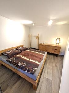 a bedroom with a large bed and a dresser at Ferienwohnung im ehemaligen Gesindehaus in Welschbillig