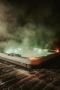 a laptop computer sitting on a table with smoke at Villa ADurbuy avec Jacuzzi in Durbuy