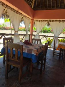 a dining room with a table and some chairs at SAMAKI VILLAGE in Watamu