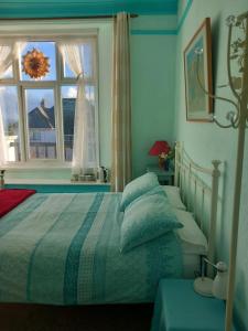 a bedroom with a bed with pillows and a window at Falmouth Lodge in Falmouth
