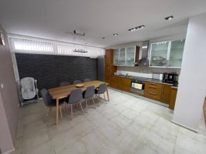 a kitchen with a wooden table and chairs at JD Apartment in Liptovský Mikuláš