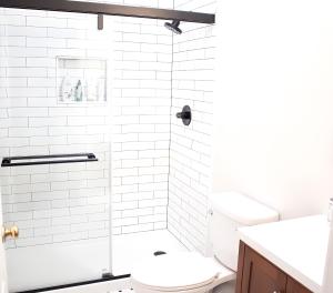 a white bathroom with a toilet and a shower at Hygge, Upscale & Relaxing Luxury in Potomac