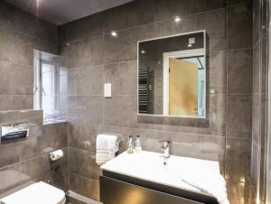 a bathroom with a sink and a mirror at Ty Siam in Newborough +36 photos