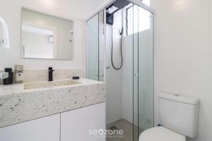a bathroom with a shower and a toilet and a sink at Apto confortável vista mar em Floripa EVA704 in Florianópolis +12 photos