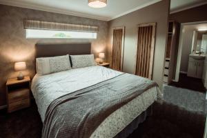 a bedroom with a large bed and a window at Applegrove Country Park, Scarborough with Private Hot Tubs in Burniston