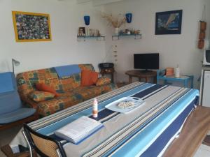 a large bed in a living room with a couch at Chez Édouard et Aline in Ploubazlanec