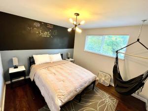 a bedroom with a hammock bed and a window at Spacious Retreat w/ Hot Tub. Perfect for Families in Edmonds