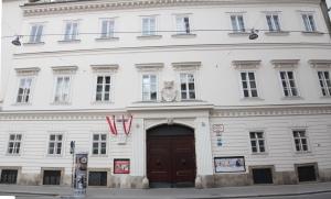 a large white building with a brown door at DATRI Petite Suite 10 in Vienna