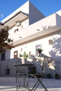 a table and a chair in front of a building at B&B ILSE in Capua