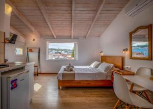 a bedroom with a bed and a large window at Nonna Irene in Rethymno