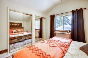 a bedroom with a bed and a large mirror at Solitude Mountain Cabin Creek-Side View and Hot Tub in Brighton
