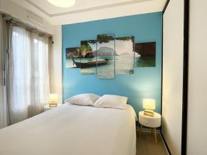 um quarto com uma cama e uma parede azul em L'Escapade em Chartres