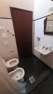 a bathroom with a toilet and a sink at Tolita in Villa del Totoral