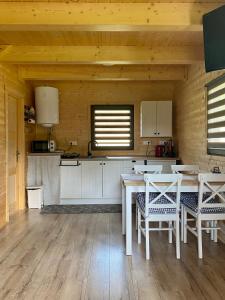 a kitchen with a table and chairs in a room at Chata Oliva in Banský Studenec