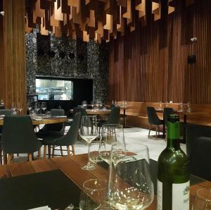 a dining room with a bottle of wine on a table at Ilusion hotel flat in Natal