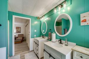 a bathroom with two sinks and two mirrors at Near Hiking and Wineries Charming Camp Verde Home! in Camp Verde +20 photos