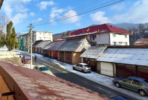 a city street with buildings and cars on the road at CID APARTMENT CAVNIC in Cavnic