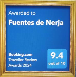a sign in a frame that says awarded to franchises de neeria at Fuentes de Nerja in Nerja