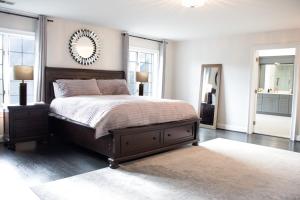 a bedroom with a bed and a mirror on the wall at Hygge, Upscale & Relaxing Luxury in Potomac