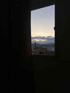 a window in a dark room looking out at the sunset at Ghadghod House in Dahab