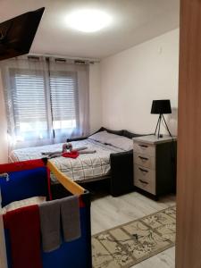 a small bedroom with a bed and a dresser at Centro Mezzano Romantica, affitto camere in Mezzano