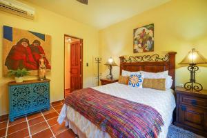 a bedroom with a bed and a painting on the wall at Wonderful 3 Bedrooms & 3 Bathrooms Home in Loreto +32 photos