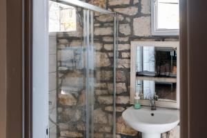 a bathroom with a sink and a shower at Himara Hostel in Himare