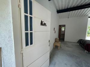 a garage door with a window and a door with a chair at Blue River in Minca