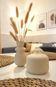 two white vases sitting on top of a table at Modern spacious apartment central of Seville in Seville