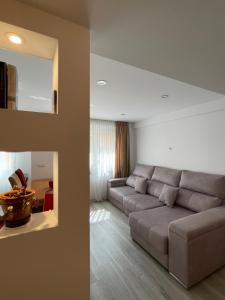 a living room with a gray couch in a room at Igidelux 2 in Villajoyosa