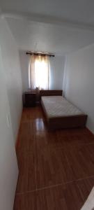 een kleine kamer met een bed en een raam bij Hospedaje Los vasquez in Linares