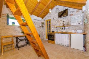 a kitchen with a wooden ladder in a room at House Vinko in Račišće
